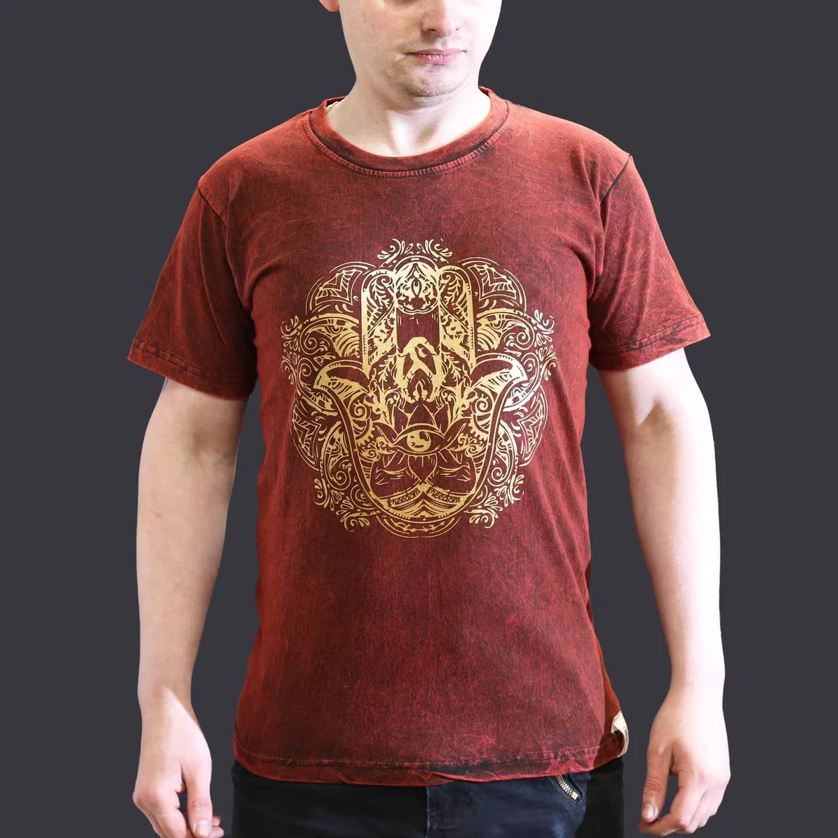 Maroon small size t-shirt with stone washed fabric and Hamsa hand design on front, laid flat on white background