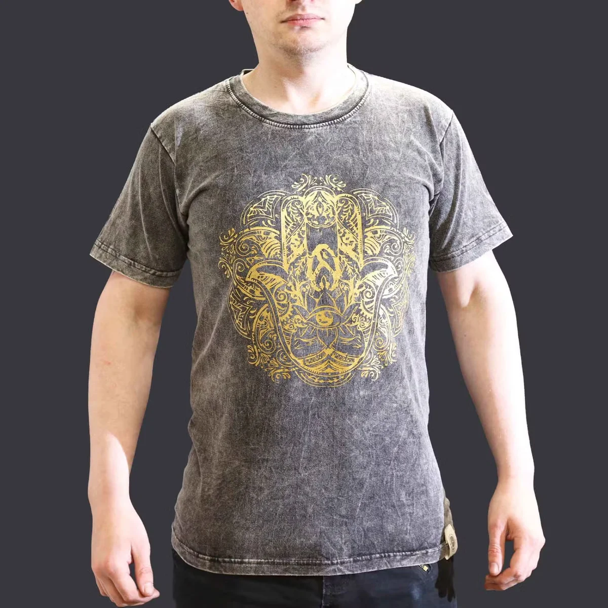 Dark grey small graphic tee featuring a small stone washed finish and a Hamsa hand design on front