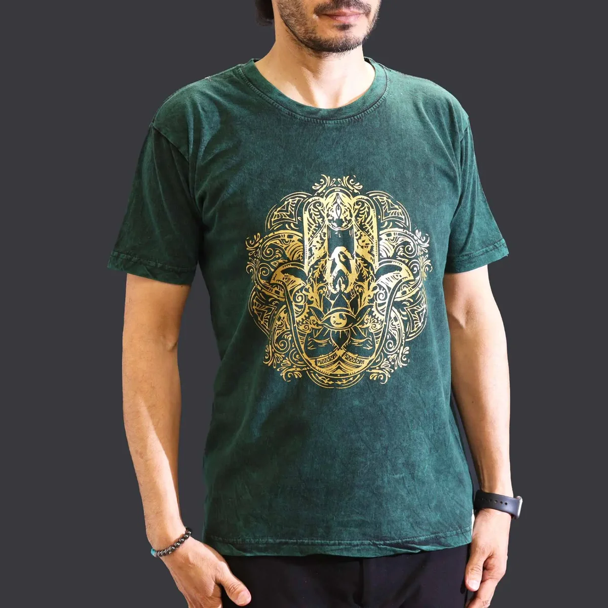 Green medium stone washed t‑shirt with a hamsa symbol on the front.