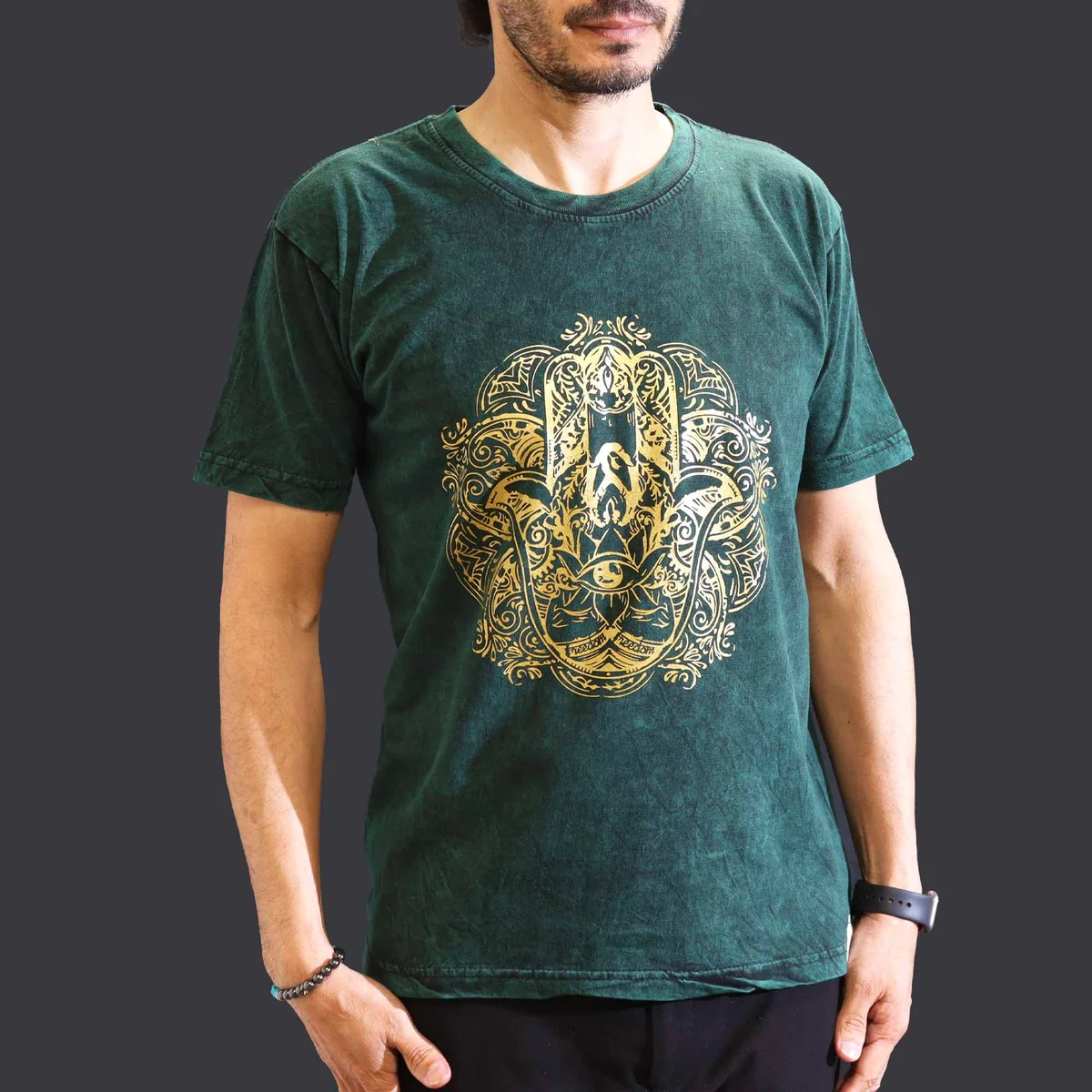 Green stone washed t‑shirt featuring a hamsa symbol on the chest.