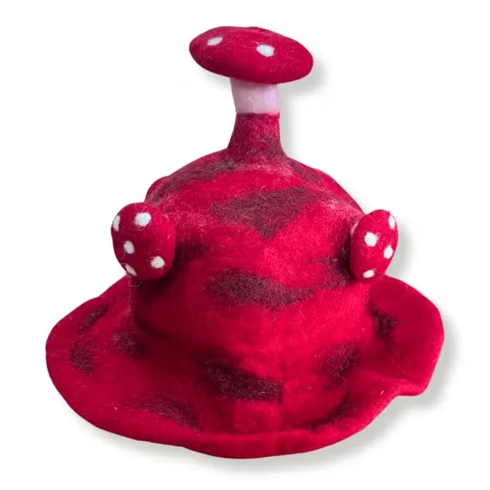 Red felted mushroom hat styled as a unique novelty hat with detailed textures, shown on a plain background
