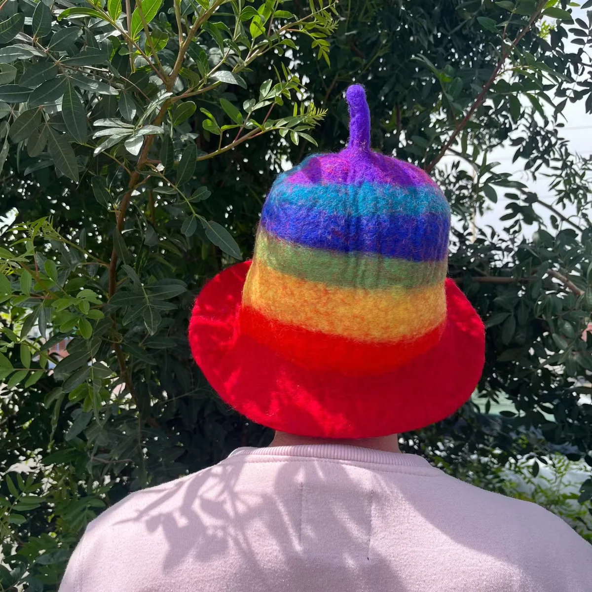Rainbow felted wool hat with multicolored sauna bowl design.