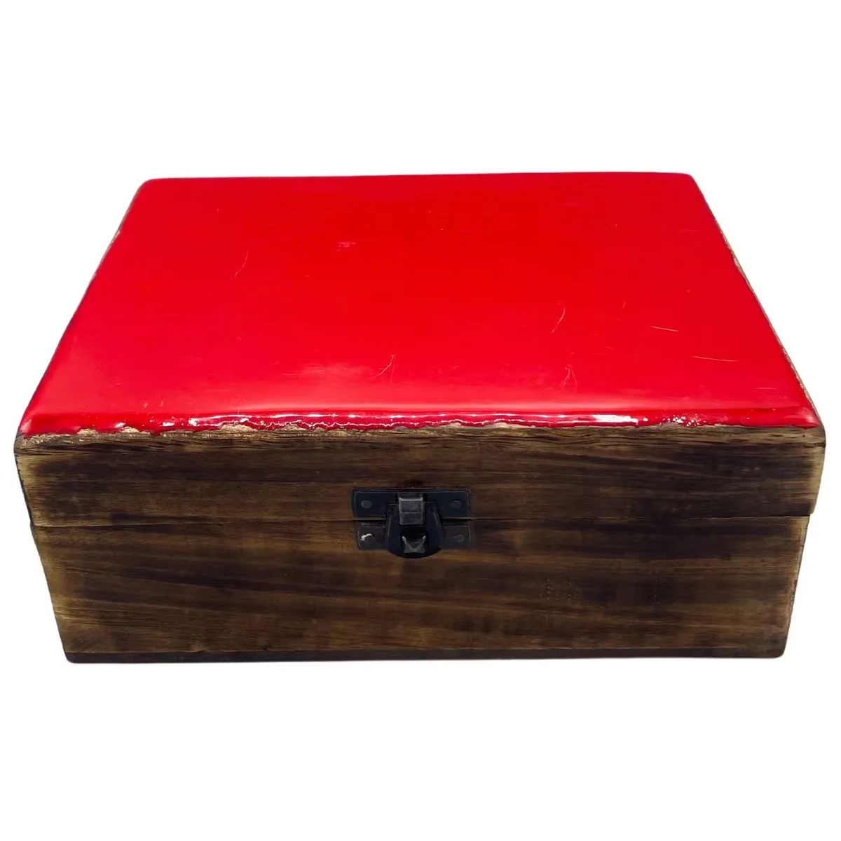 Red ceramic box made of glazed ceramic and wood, showing its lid and a small wooden base, viewed from the front.