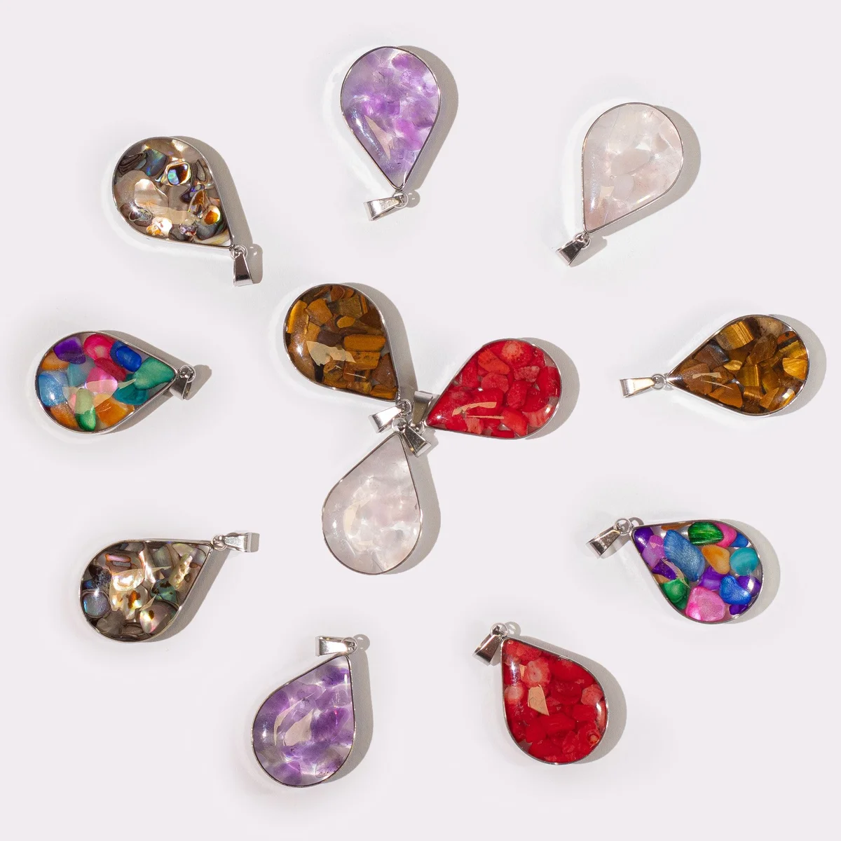 Steel cased pendant featuring 12 colourful gemstone chips and shell accents, pendant set against a neutral background.