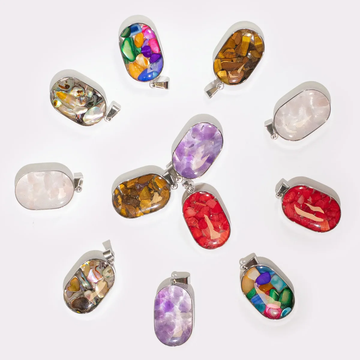Metallic pendant featuring 12 assorted gemstone chips and shells, oval shape