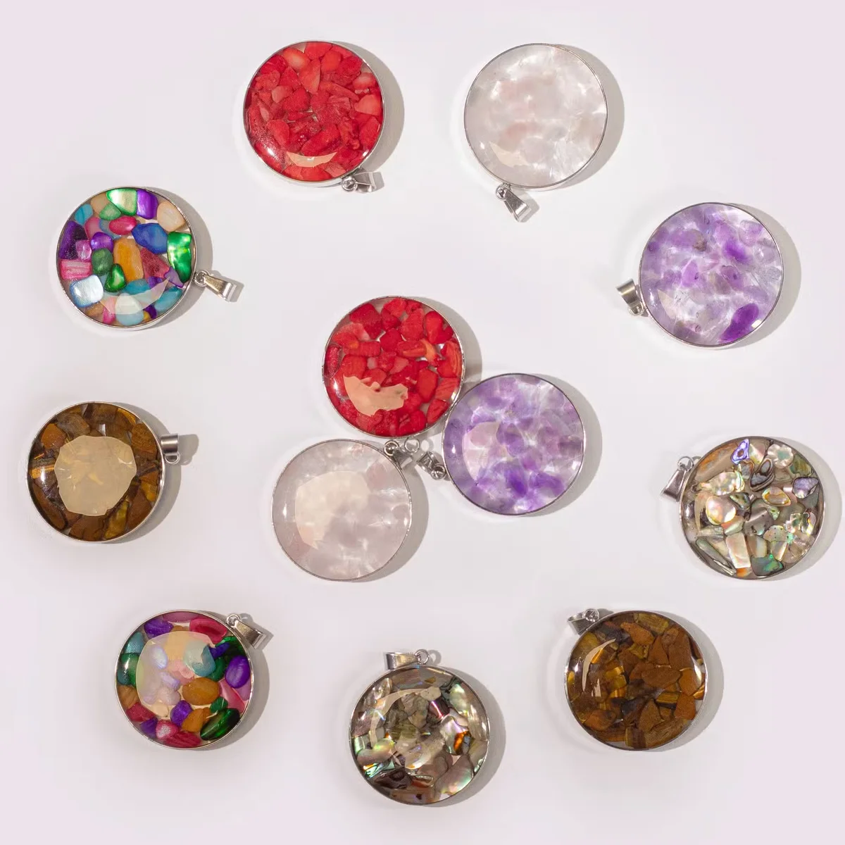Round steel‑cased pendant featuring assorted gemstone chips and shell accents, highlighted as a shell pendant necklace.