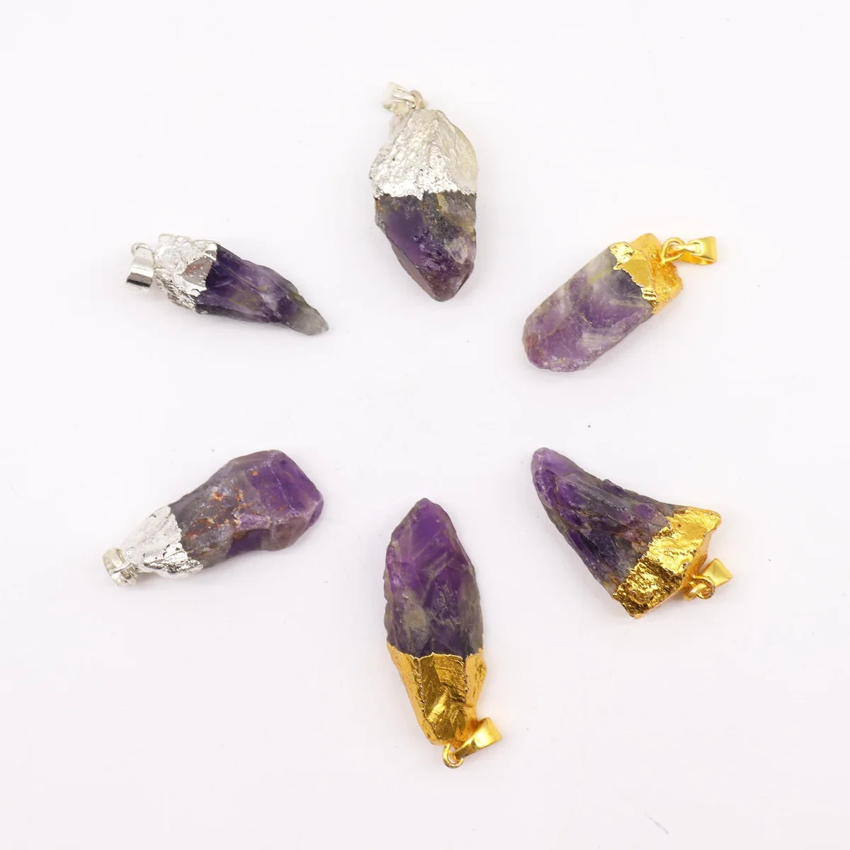 Six assorted amethyst pendants with gold and silver plating, displayed on ornate chains