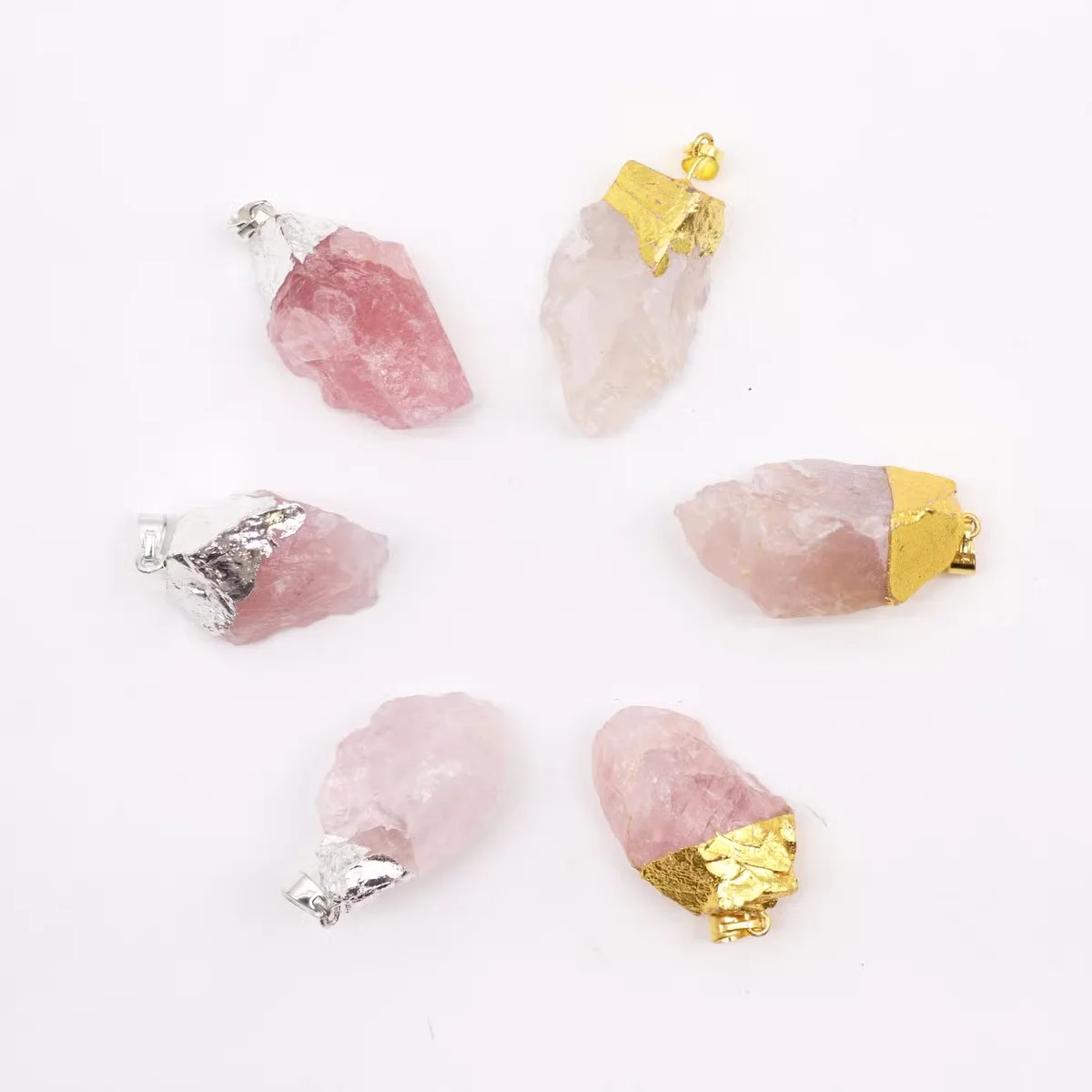 Six rose quartz pendants in gold and silver plating displayed together, showcasing silver plated pendants