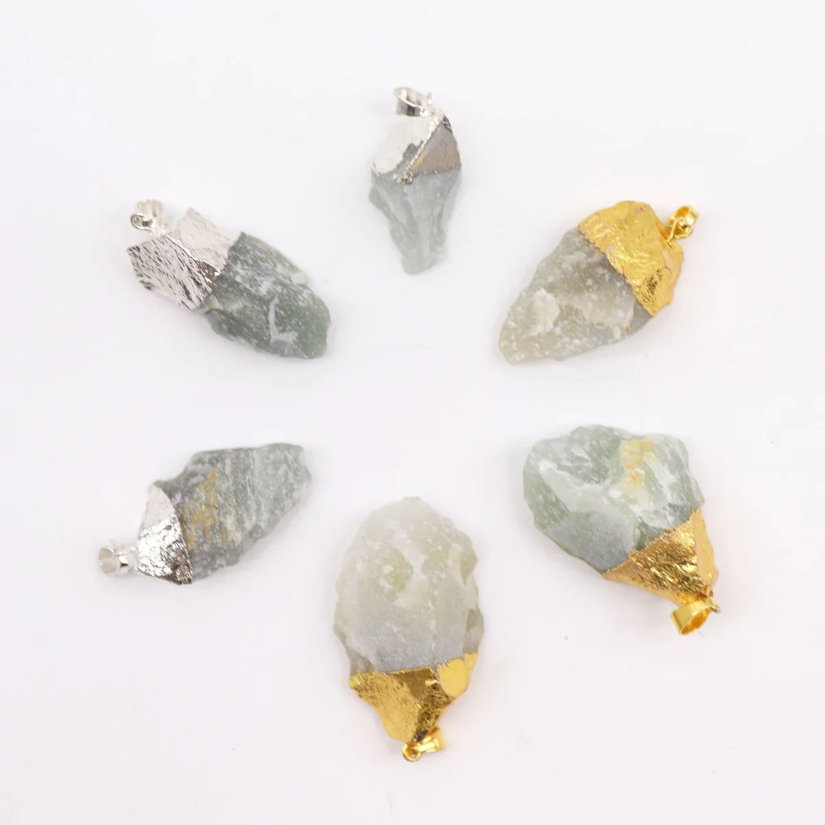 Assorted silver‑plated pendants with blue sodalite gemstones displayed on a white background.