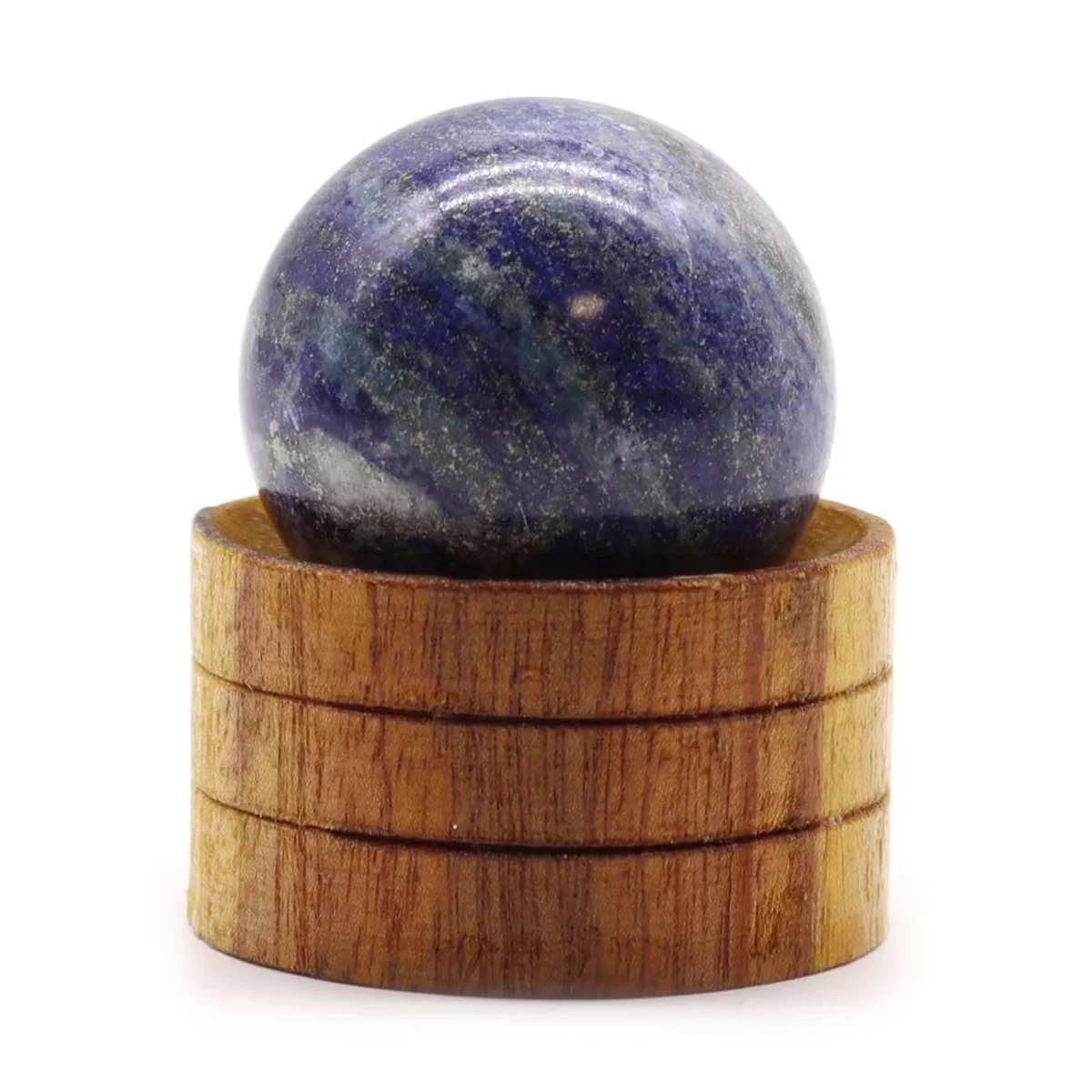 Decorative gemstone sphere 40mm Afghan Lapis blue stone on a small stand against white background