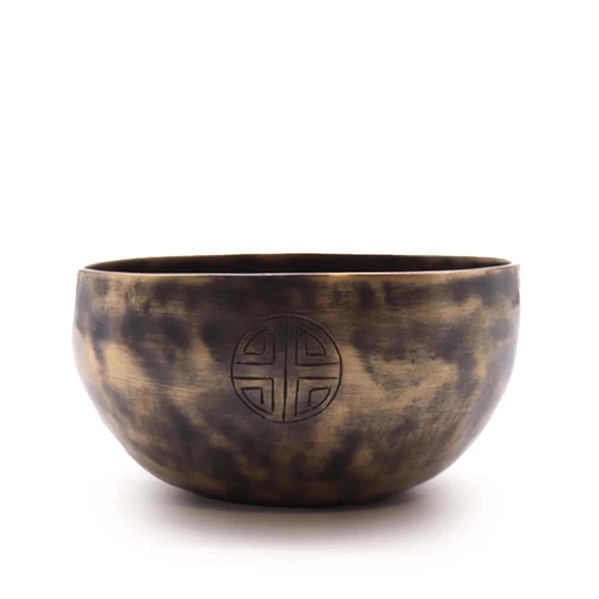 Small Indian moon phase singing bowl resting on white surface, silver rim highlighted by natural light