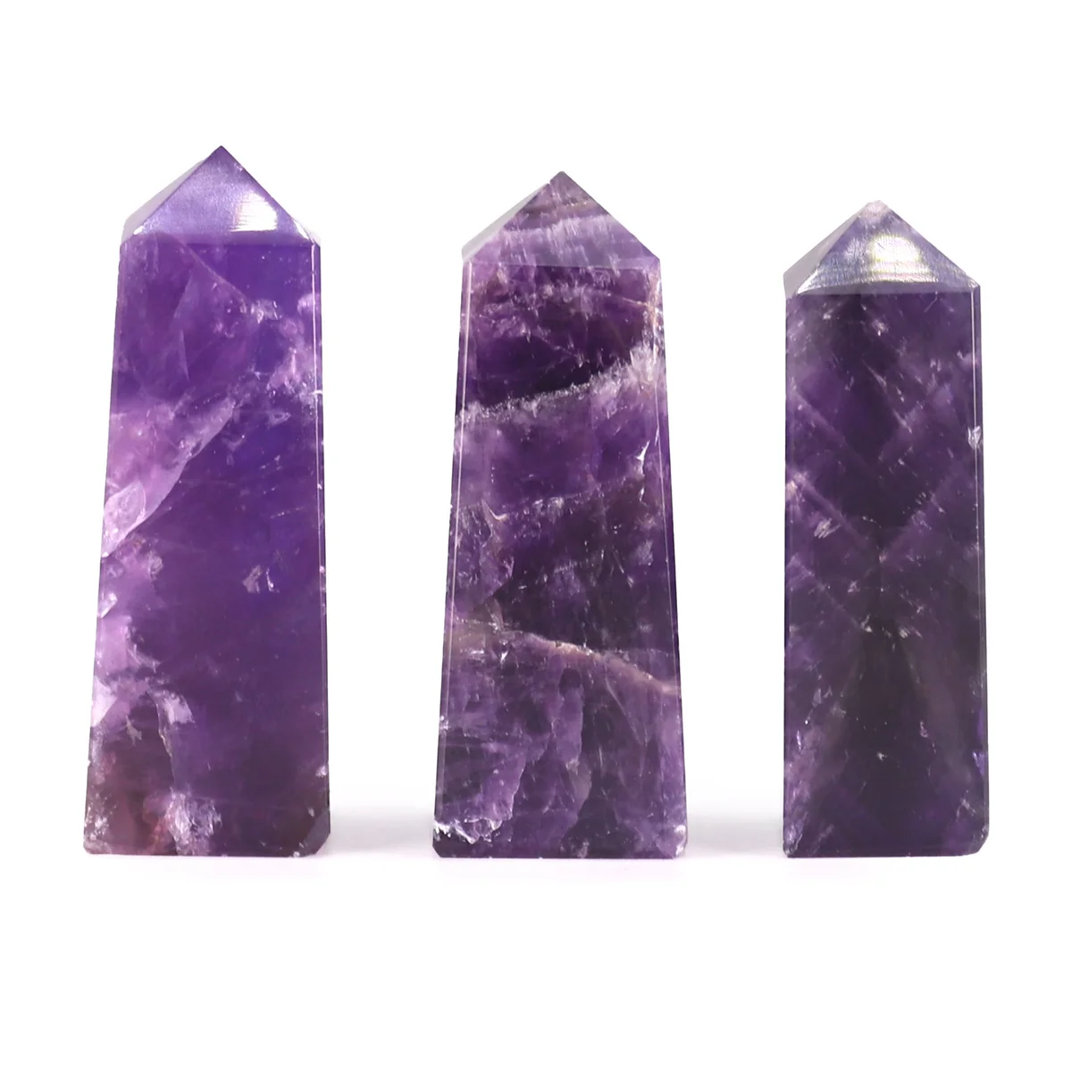 Polished African amethyst obelisk gemstone point approximately 5cm tall with purple hues and natural crystal texture