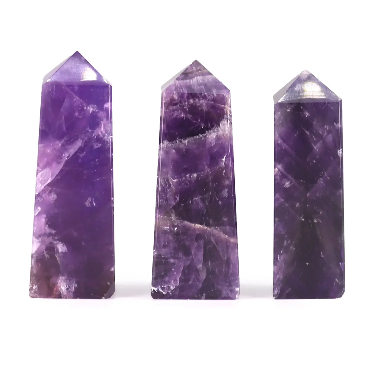 Single 5cm African Amethyst gemstone obelisk point with purple hues on a white background