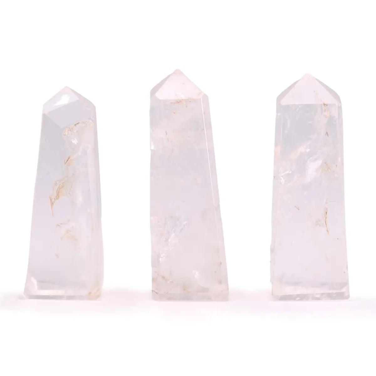 Three clear quartz decor gemstone obelisk points, each approximately 5cm tall, standing upright on a white surface