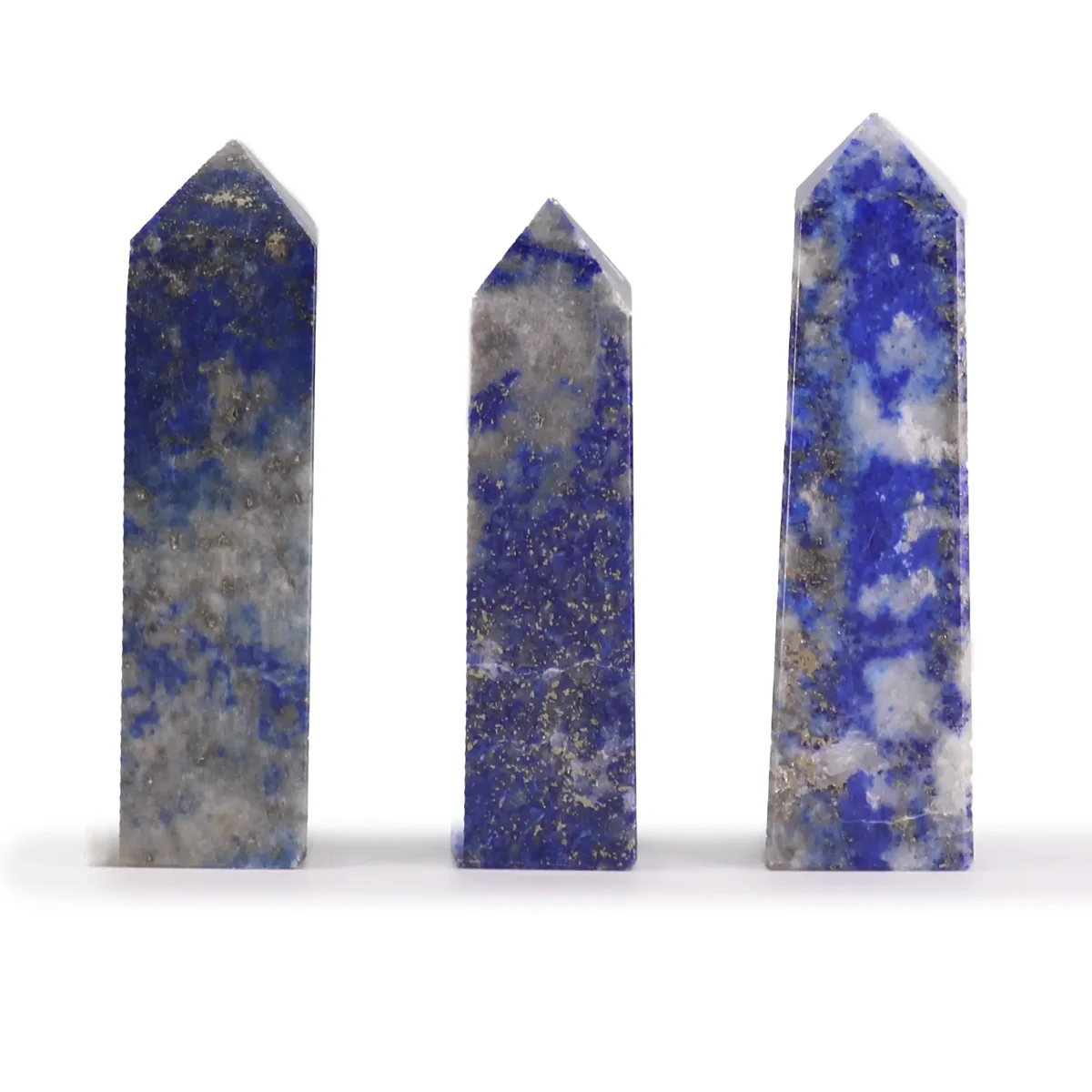 Afghan Lapis gemstone obelisk point approx 5cm with deep blue and white speckled patterns on a white background