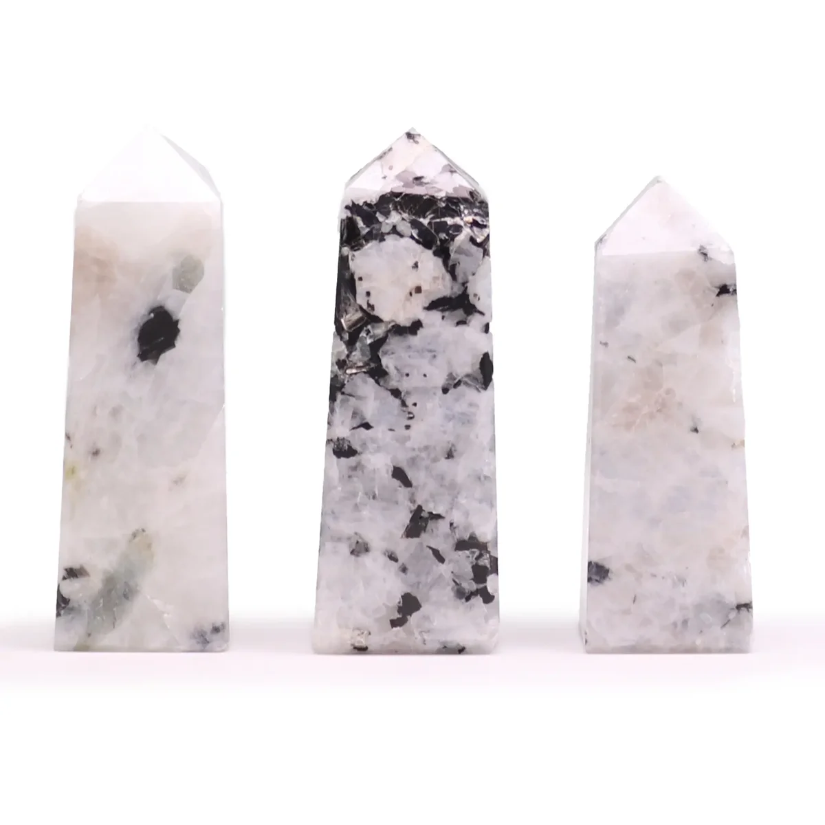 Moonstone gemstone obelisk point approximately 5cm tall with smooth polished surface on white background