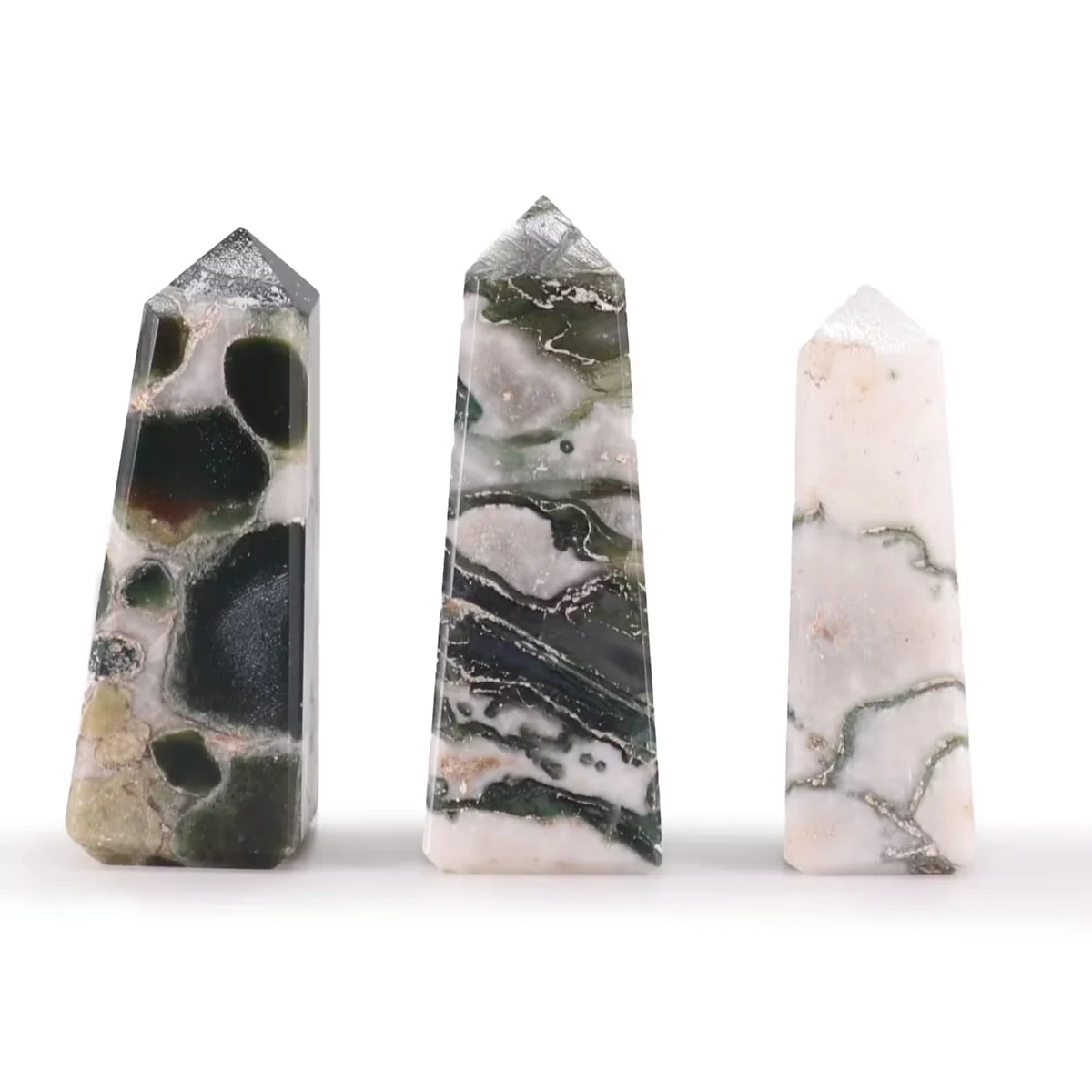 Decorative moss agate gemstone obelisk point about 5cm tall with green and white natural patterns on white background