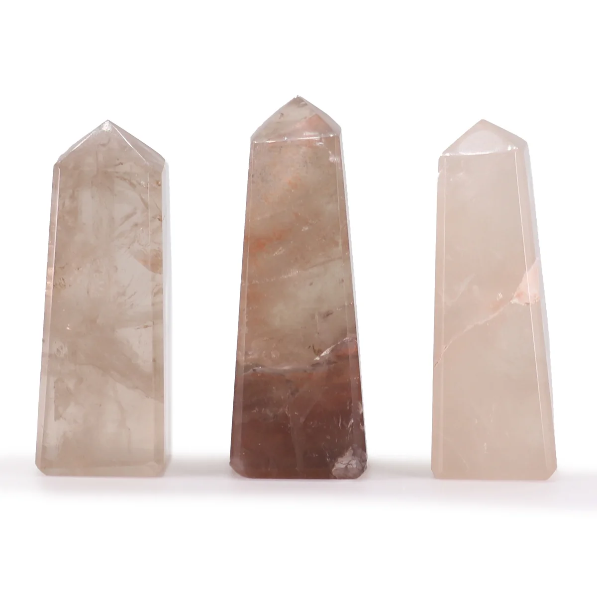 Two 5cm quartz ornament smokey quartz gemstone obelisk points standing upright on a white background