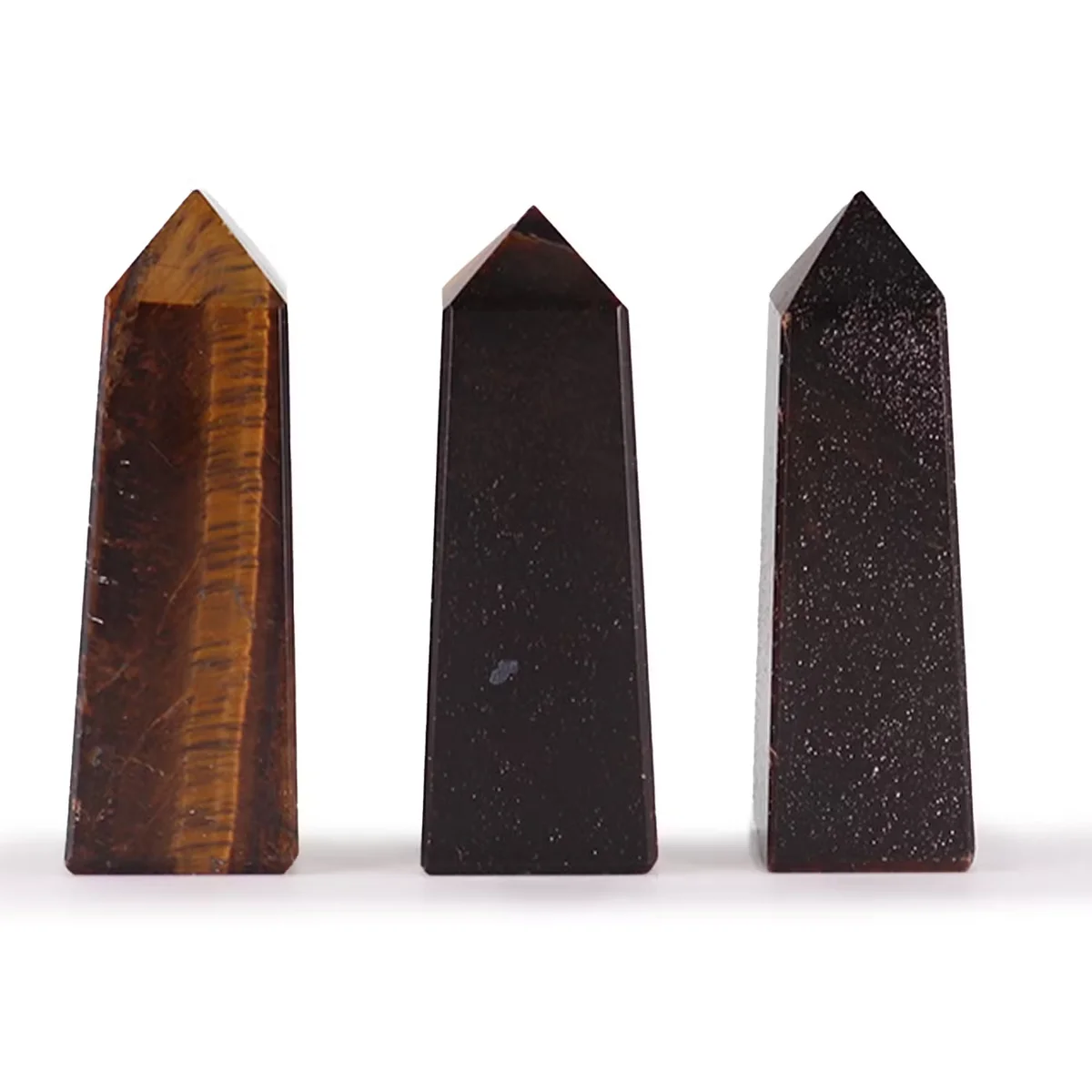 Three polished tiger eye ornament obelisk points standing upright, each approximately 5cm tall, with rich brown and gold bands