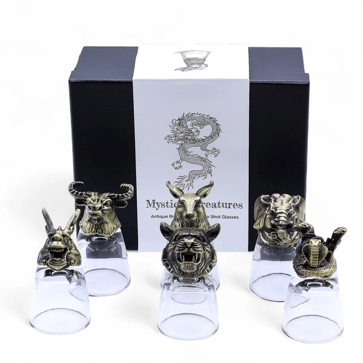 Set of six antique bronze 50ml shot glasses featuring mystical creature designs displayed on wooden surface
