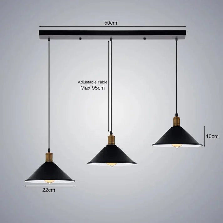 Three-head adjustable pendant lamp with vintage metal shades hanging above a counter in a modern kitchen setting