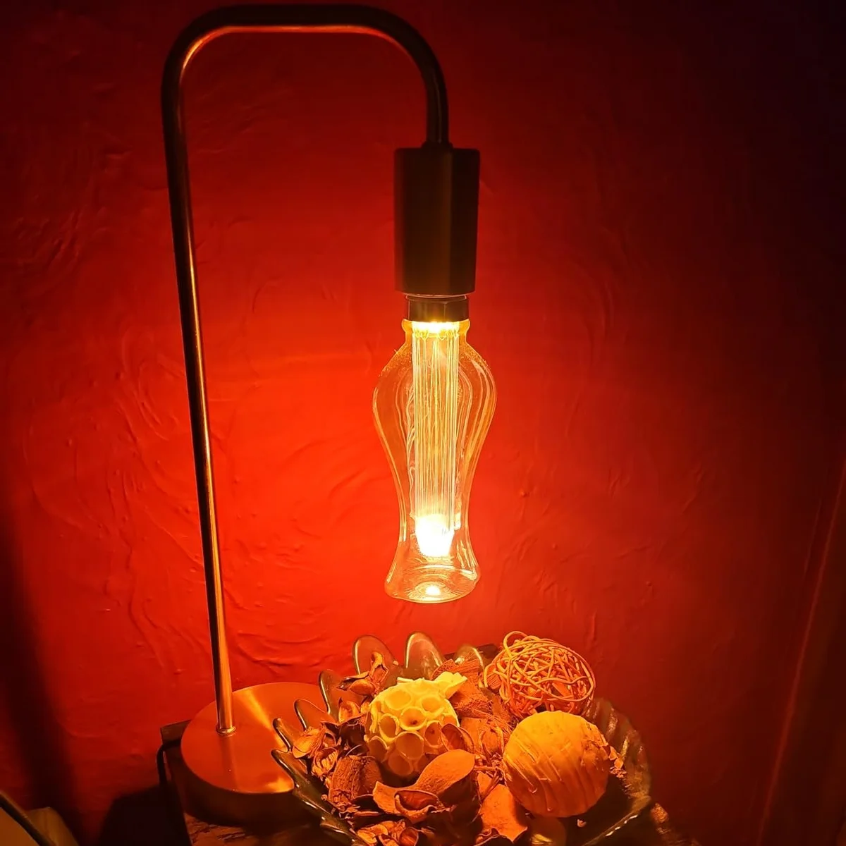 Vintage LED bulb with amber tinted glass and E27 base, glowing warm 2000K light, 3W energy-saving filament design