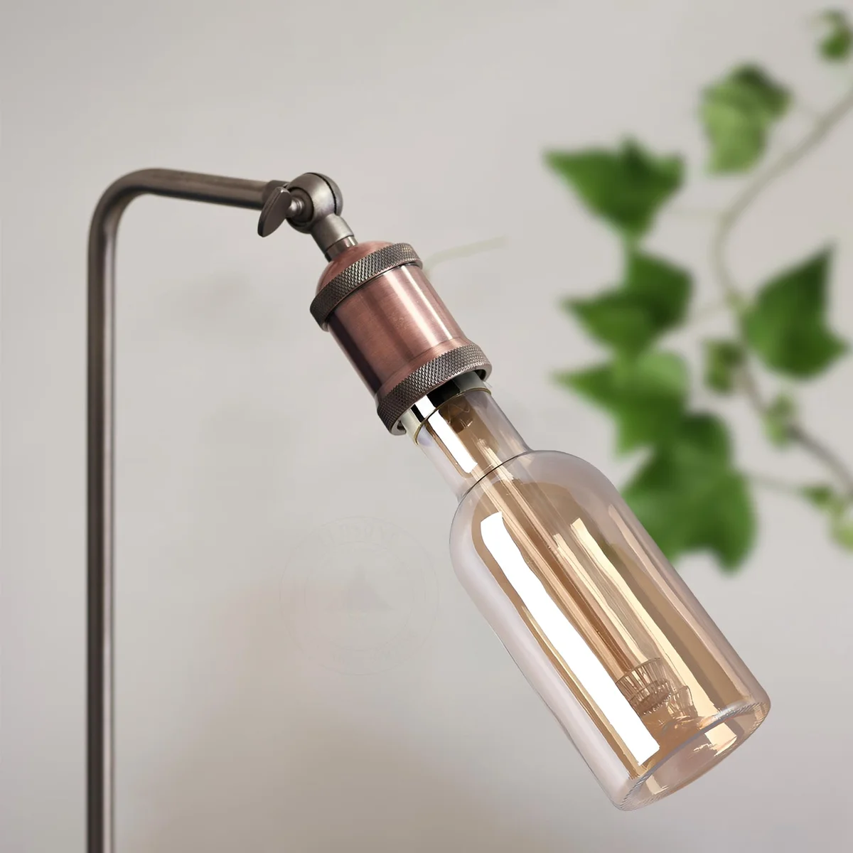 Tall tubular vintage amber glass warm white LED bulb with E27 base glowing softly against dark background