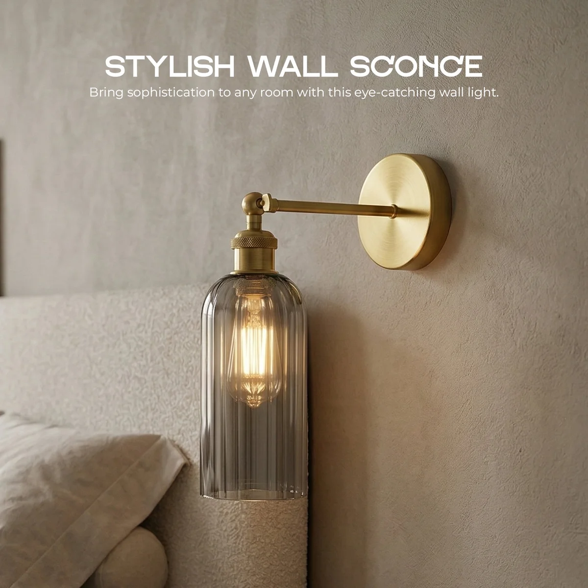 Adjustable vintage wall sconce with yellow brass finish and smoked grey glass shade mounted on white wall