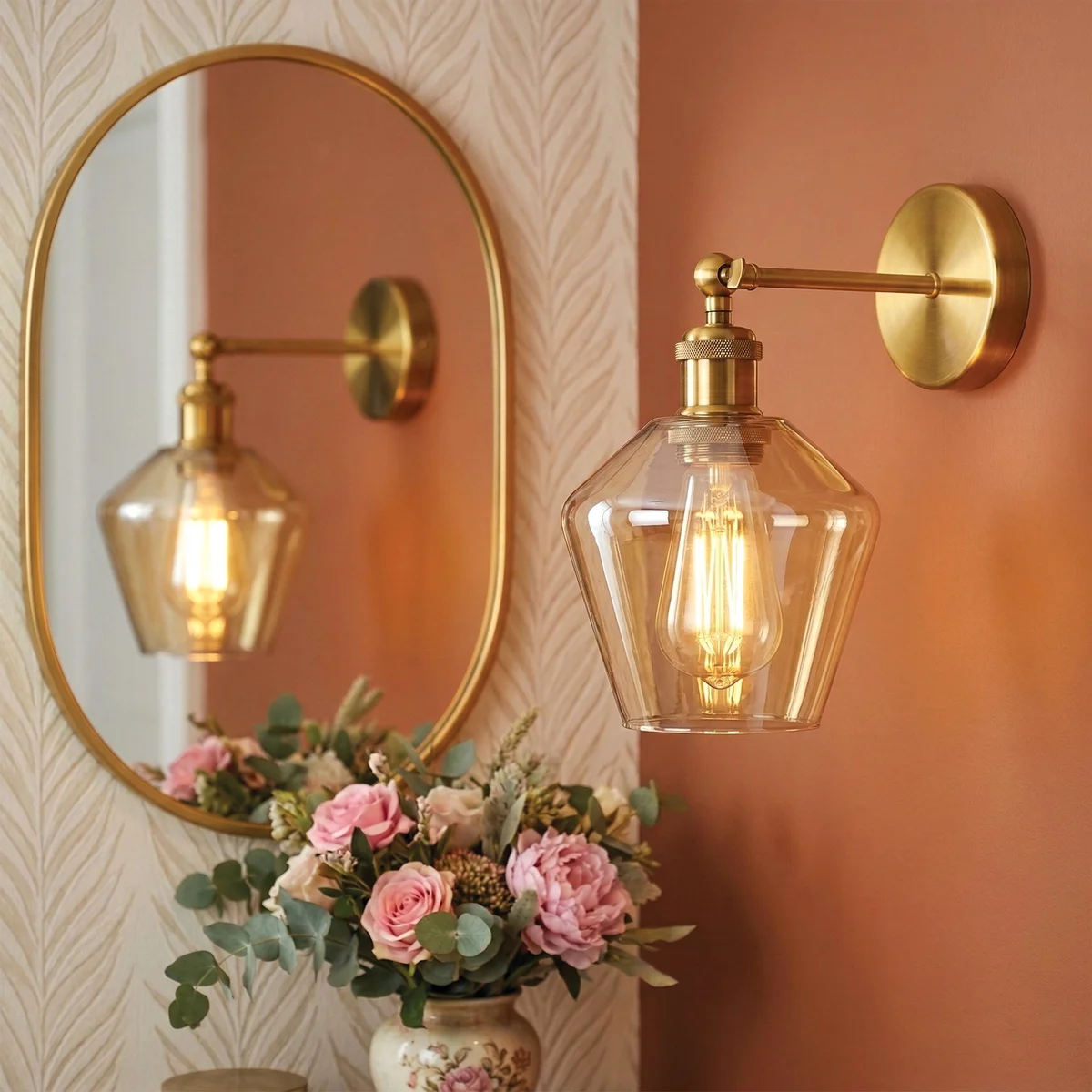 Brass plated wall lamp with adjustable swing arm and amber faceted glass shade mounted on wall