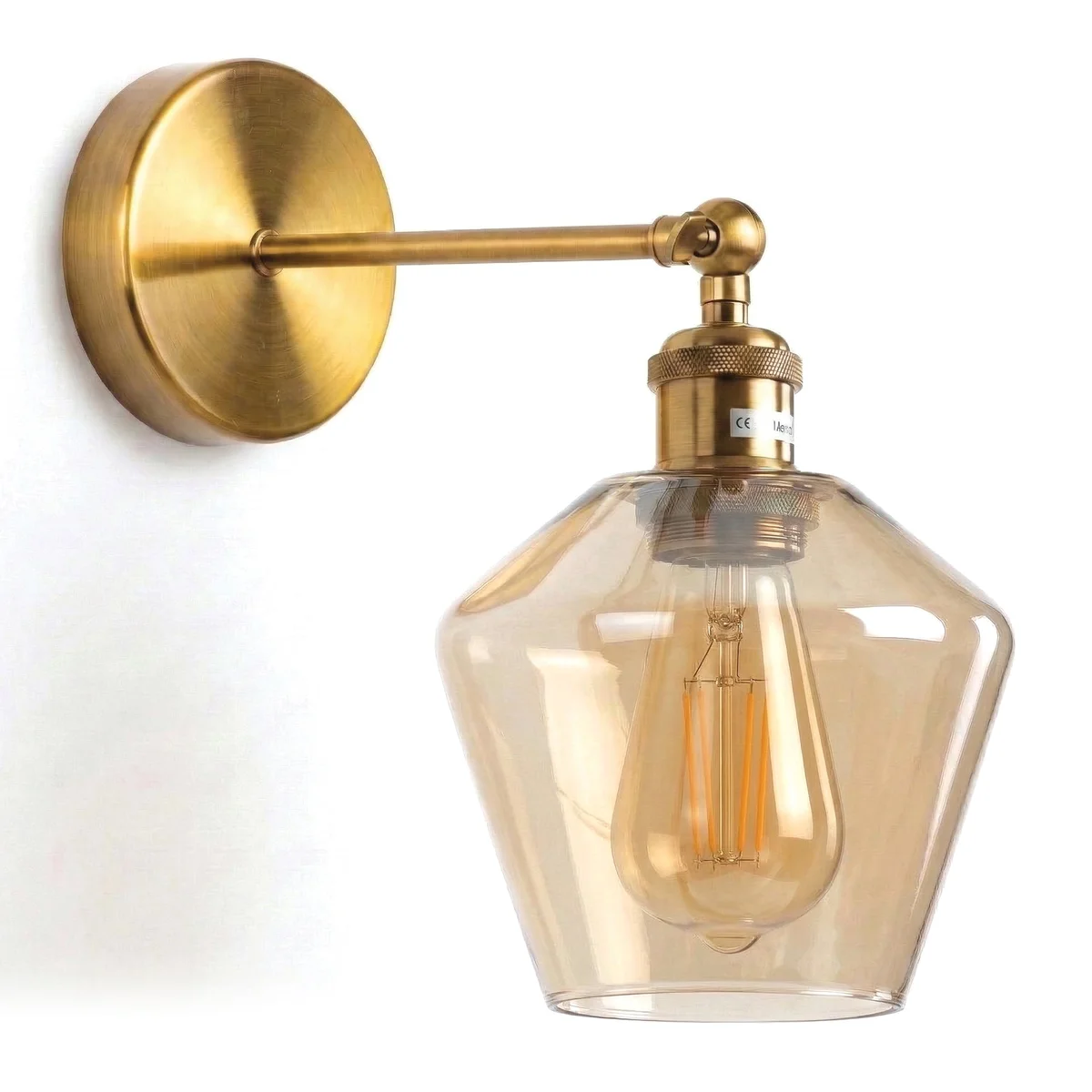 Vintage brass wall sconce with adjustable 180° swing arm and amber faceted glass shade mounted on wall