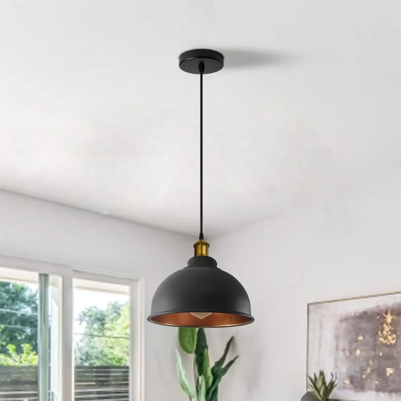 Black metal industrial pendant light with vintage design and adjustable cable hanging against a white background