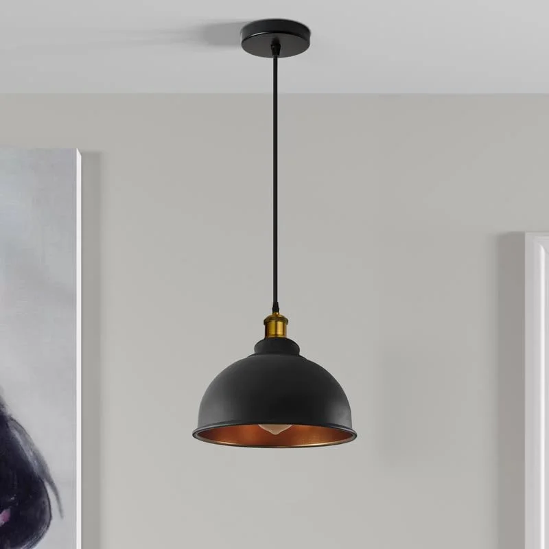 Black metal single pendant light with adjustable cable pendant hanging from ceiling against plain background