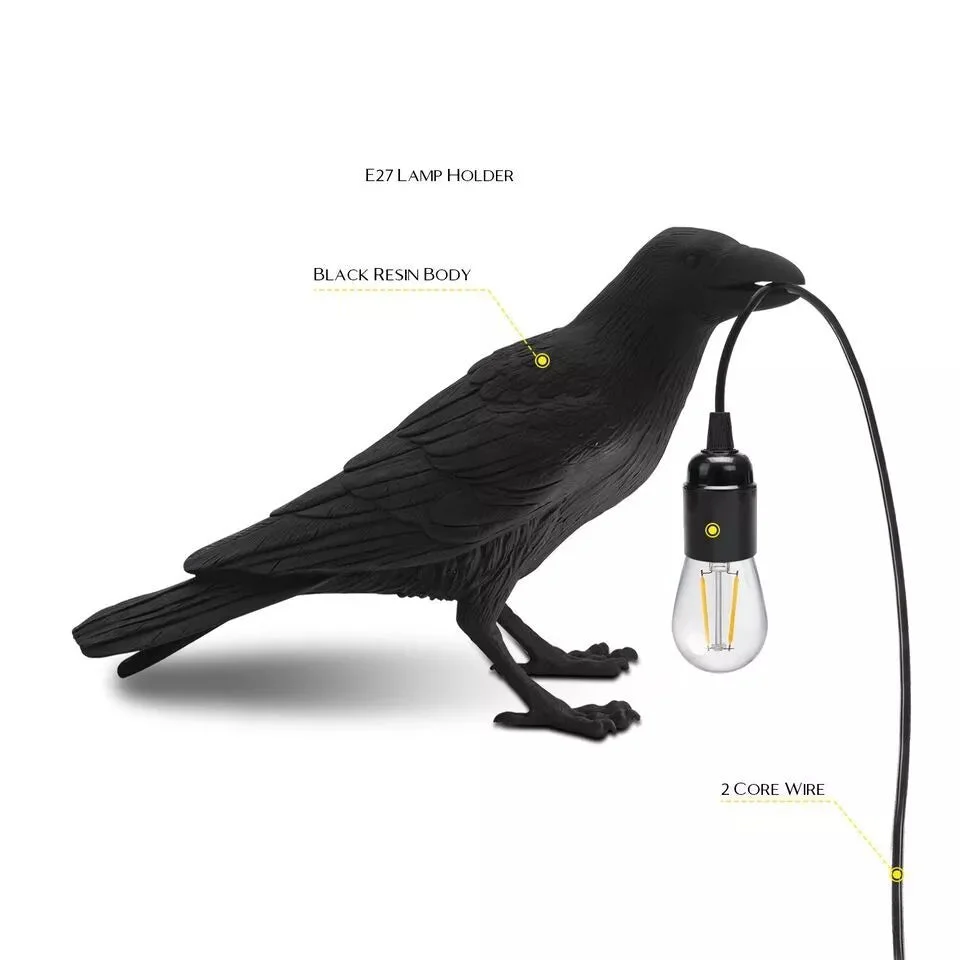 Black resin crow table lamp with E27 bulb, modern bird shape, shown on wooden surface against white background