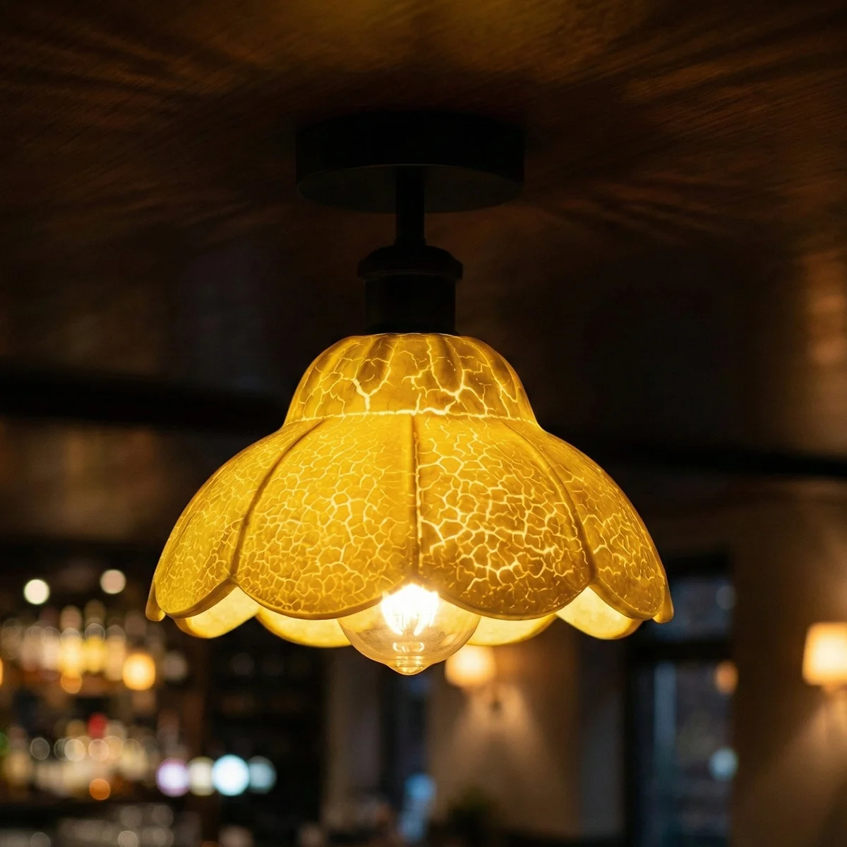 Vintage ceiling light with white crackle glass shade, black metal holder, and ceiling rose, shown from side angle