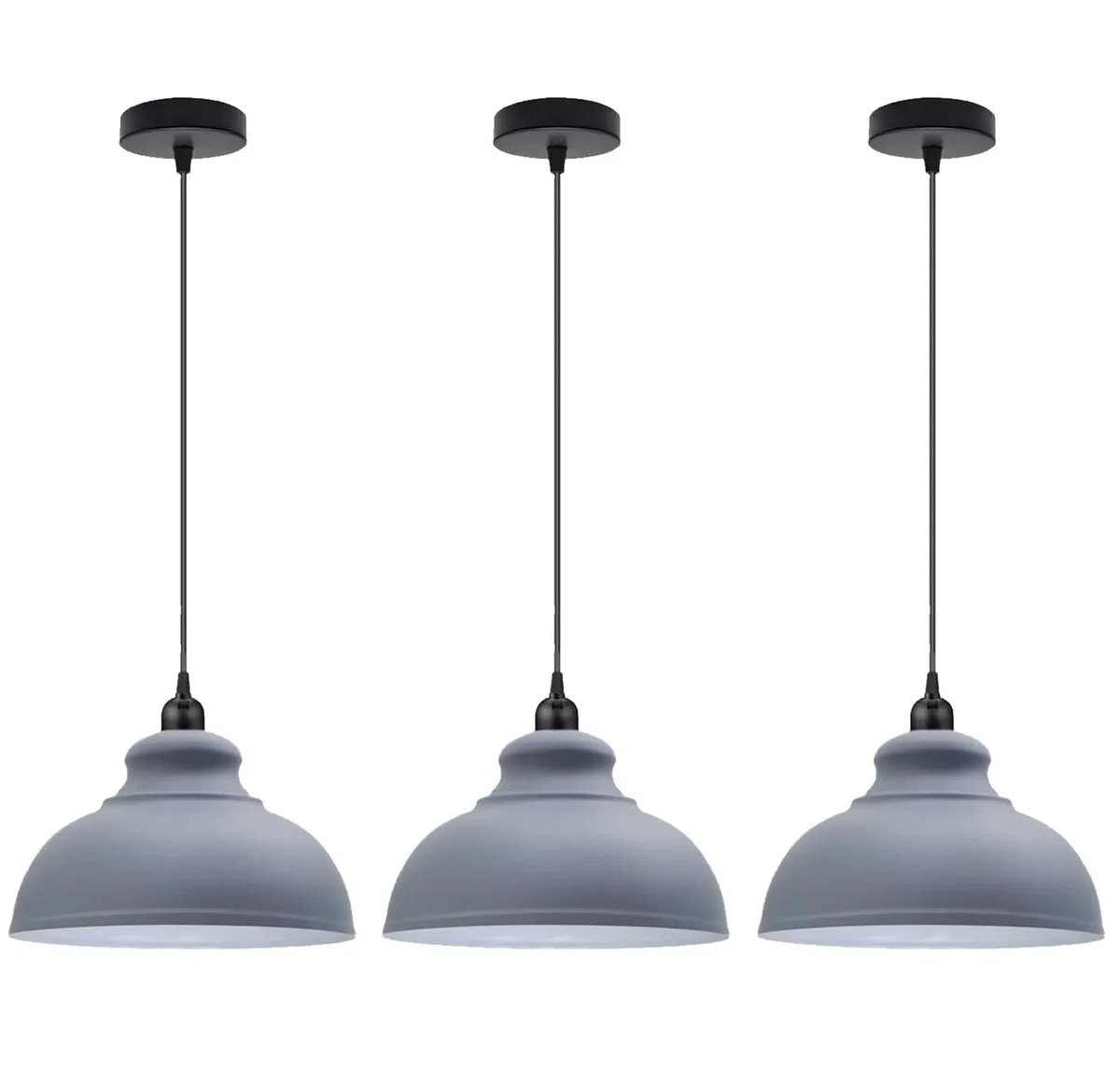 Three modern hanging lights with metal dome shades in brushed brass, black, and white, hanging at different heights