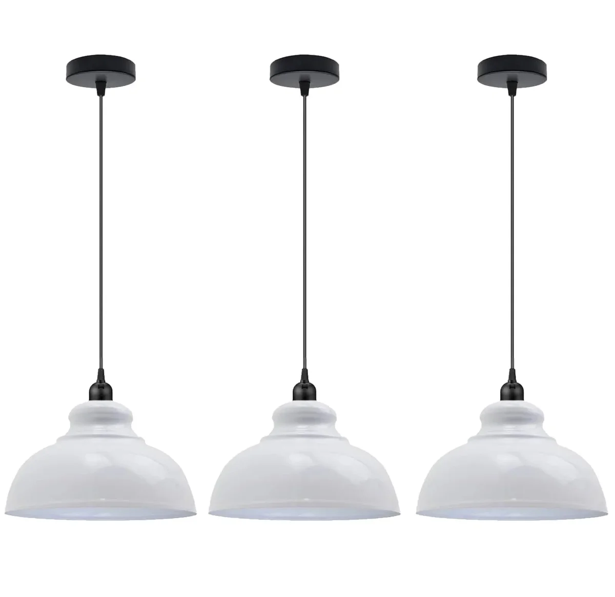 Three dome ceiling light fixtures with metal shades hanging over a modern kitchen island in brushed brass finish