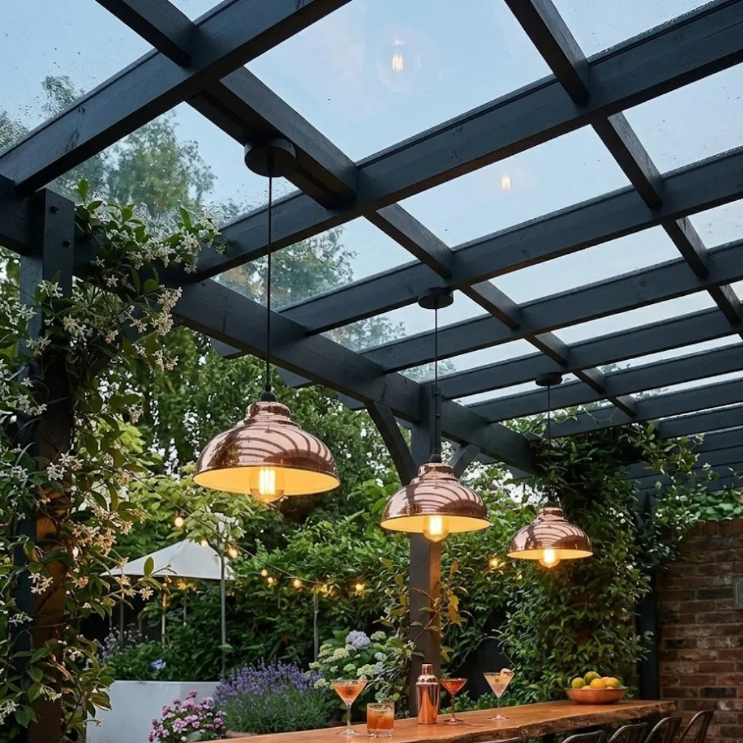 Three modern pendant ceiling lights with curved metal shades in brushed brass finish hanging from adjustable cords