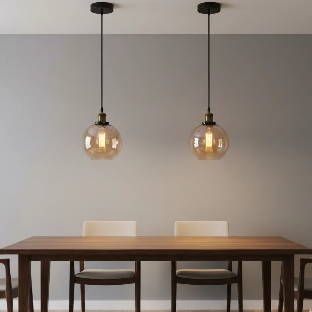 Amber vintage glass pendant light with brass hardware and intricate detailing, hanging from a ceiling cord