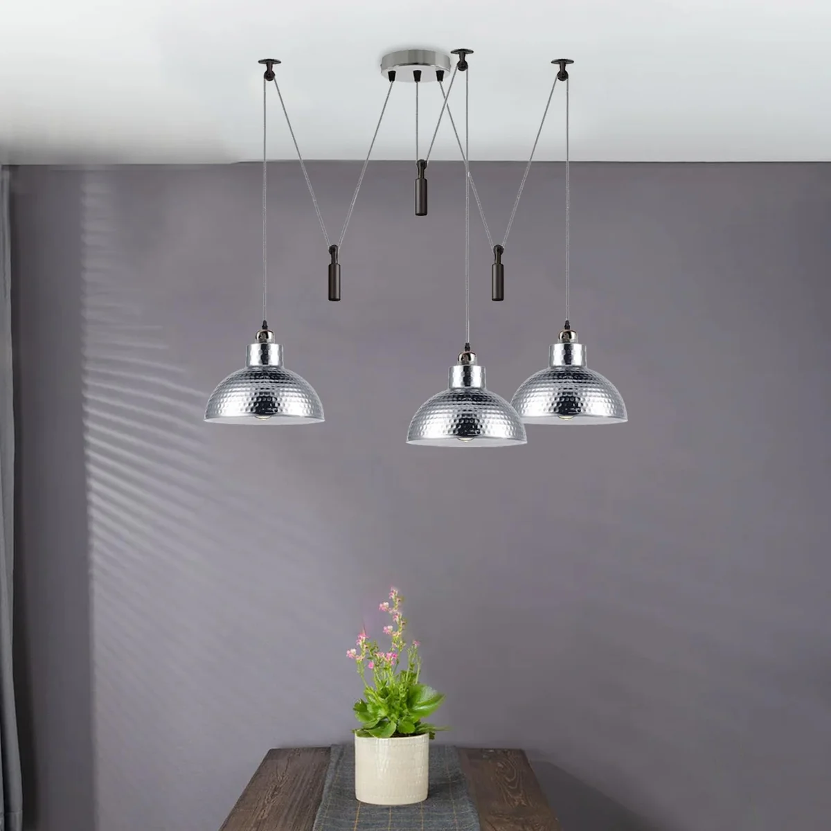 Three vintage industrial dining room pendant lights with adjustable 2M cables hanging over a wooden dining table