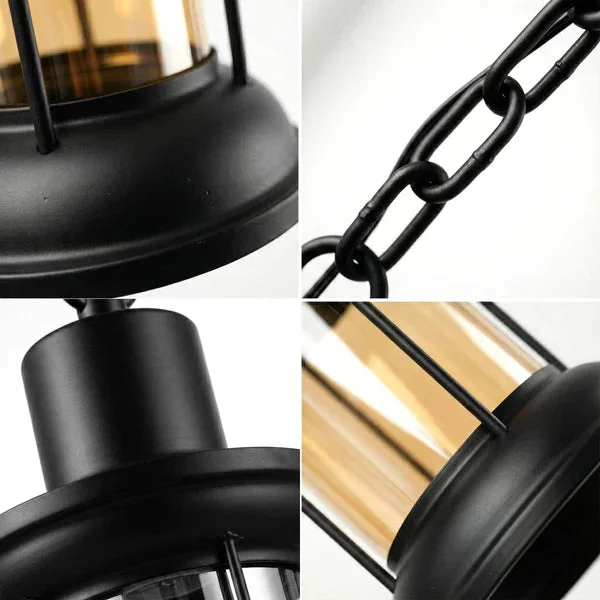 Three vintage industrial adjustable hanging lights with black metal cages and clear cylindrical glass shades hanging in a row