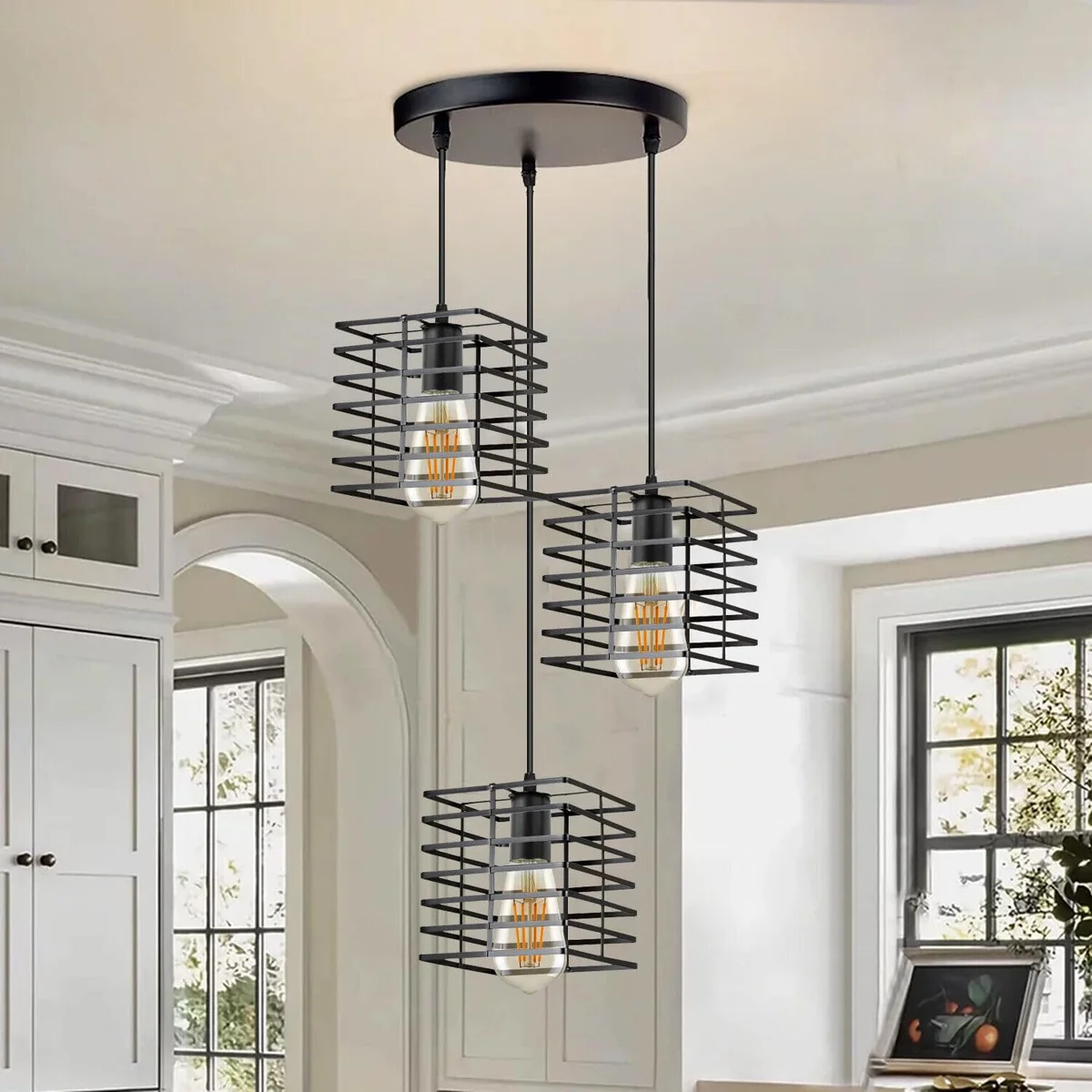 Three black pendant lamps with adjustable cords and industrial metal cage shades hanging from ceiling