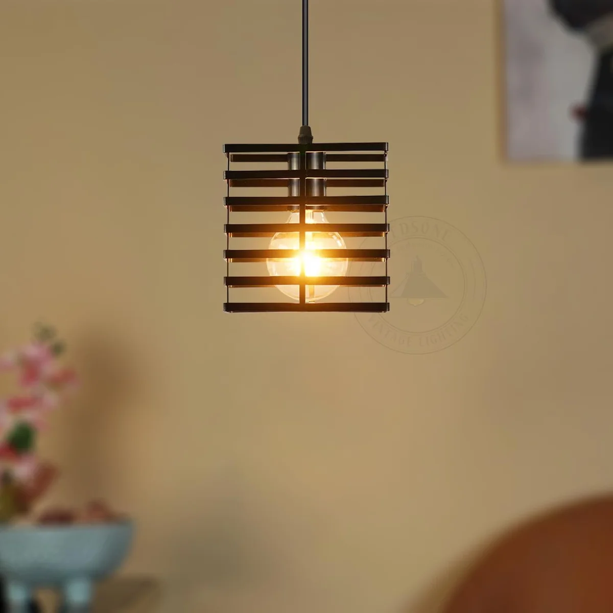 Three black metal cage adjustable pendant lights with 1m cords hanging against a white background