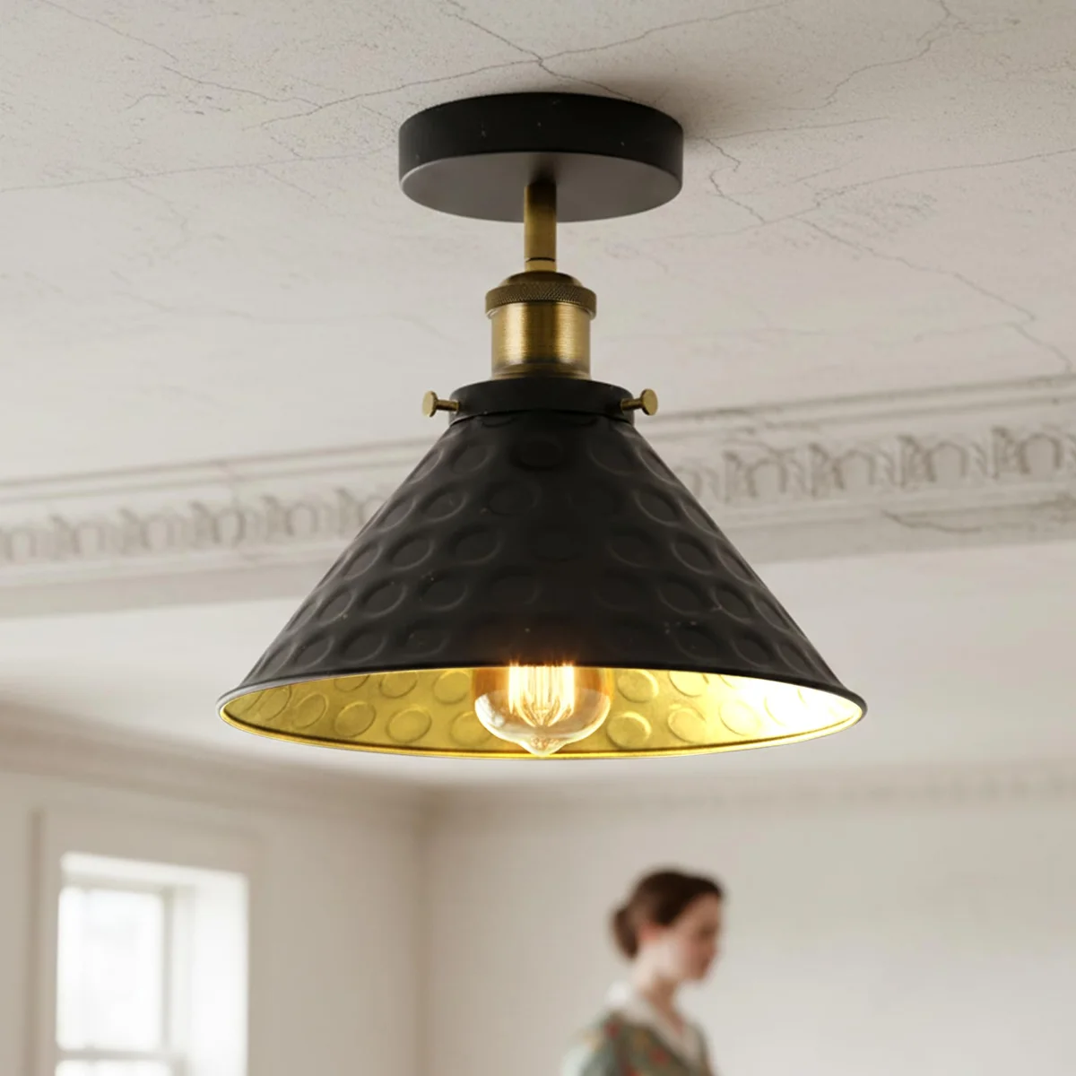 Black semi flush ceiling light with matte metal shade, hanging from ceiling, 24 cm diameter.