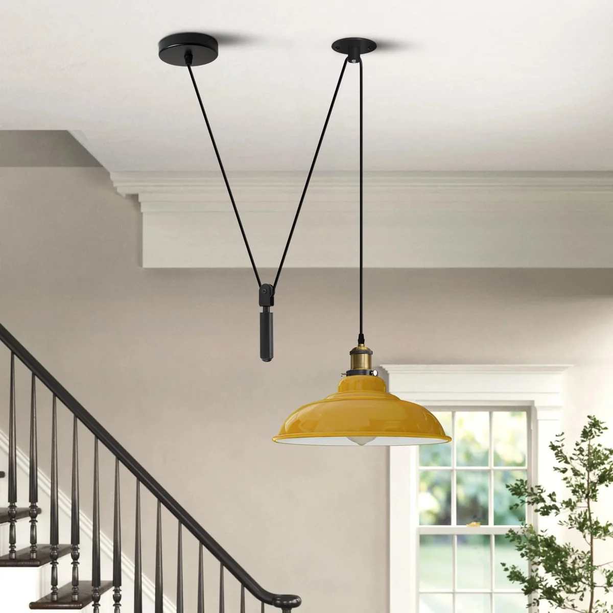 Yellow vintage adjustable pulley ceiling light with black industrial details and metal construction hanging from ceiling