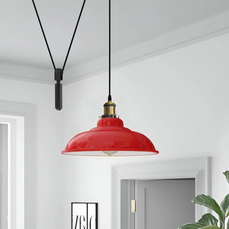 Yellow vintage adjustable pulley ceiling light with black metal pulley system and glossy finish hanging against white background