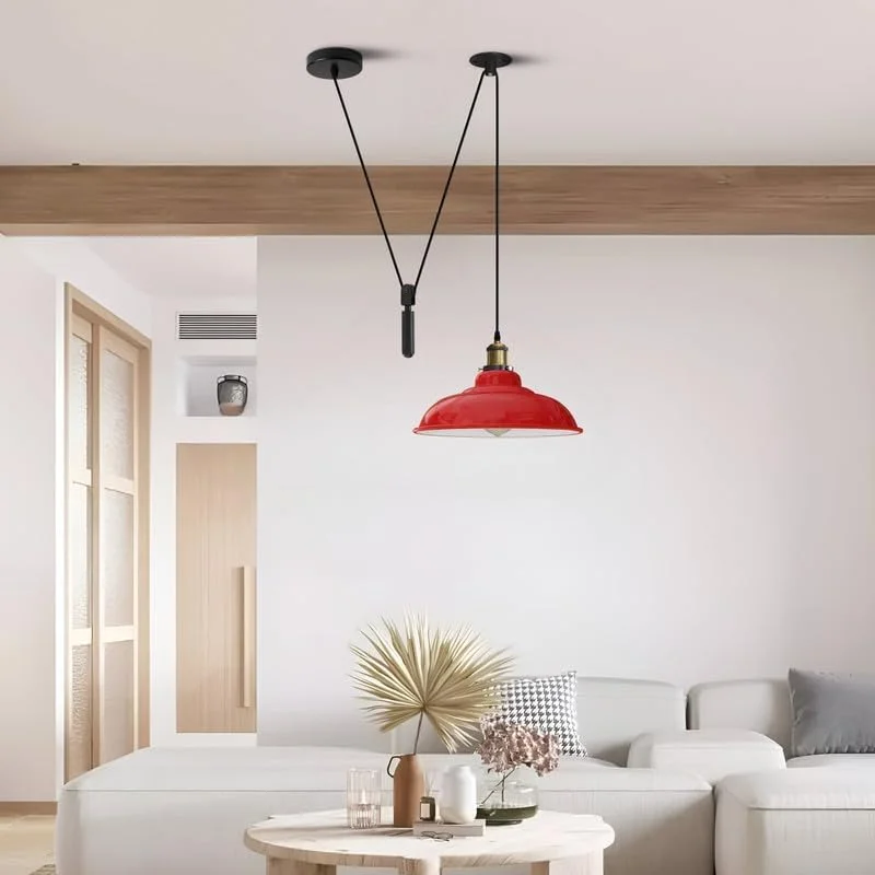 Yellow vintage adjustable pulley ceiling light with black industrial details and visible pulley mechanism hanging indoors