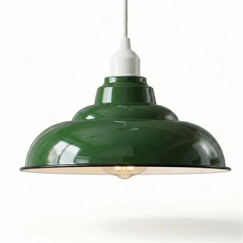 Green curved metal ceiling light shade with black rim shown hanging against white background, industrial style design