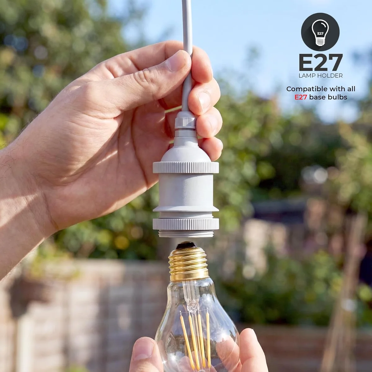 White IP44 rainproof lamp socket with E27 base and cable grip, designed for outdoor use up to 60W bulbs