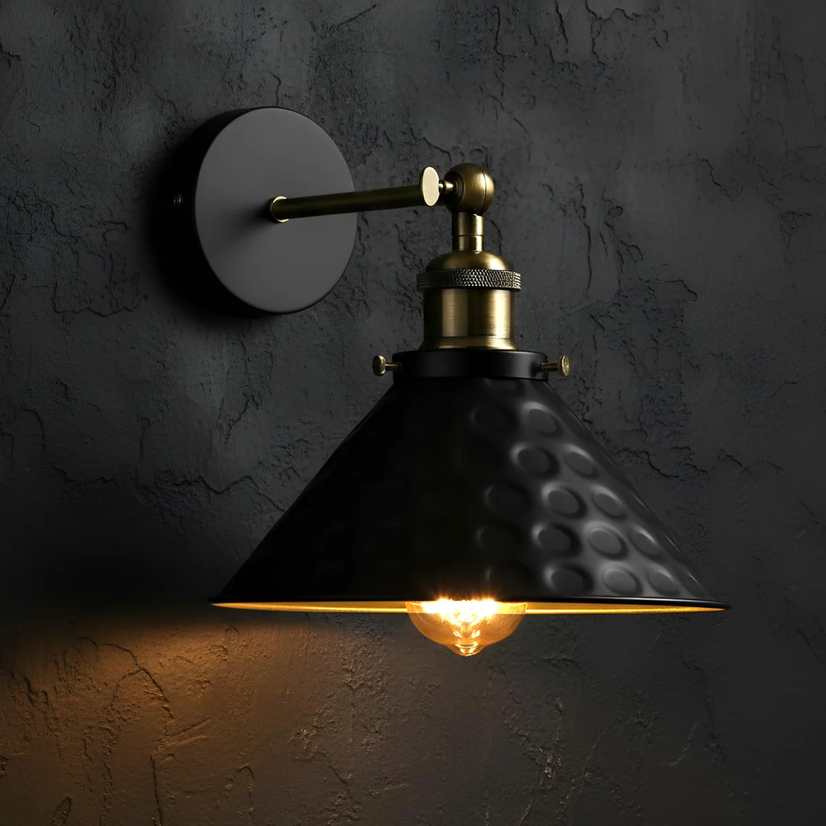 Vintage wall sconce with black metal cone shade and adjustable 180-degree swivel arm mounted on a black wall plate