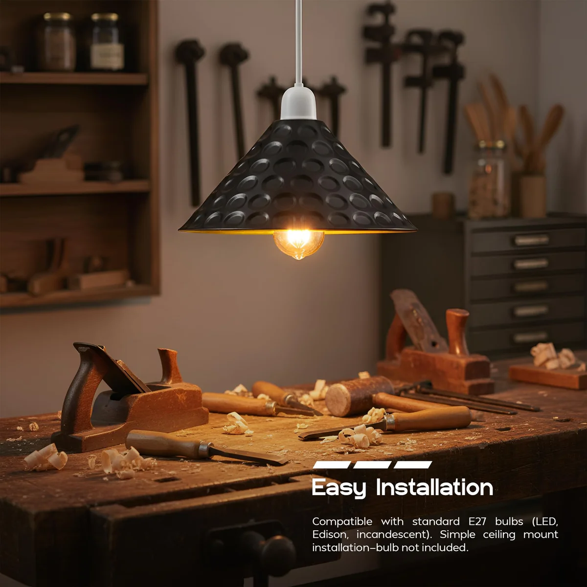 Black and gold lampshade with matte black exterior and gold interior, cone shape, shown hanging in a modern setting